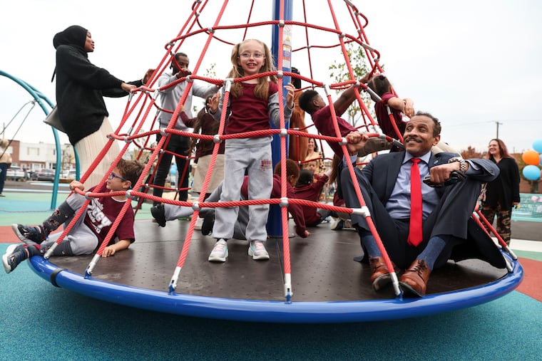 Students and Superintendent Tony B. Watlington Sr. try out the new play equipment during the schoolyard groundbreaking ceremony at F. Amedee Bregy School in South Philadelphia. The new schoolyard includes a turf field, running track, basketball court and other playground equipment.
