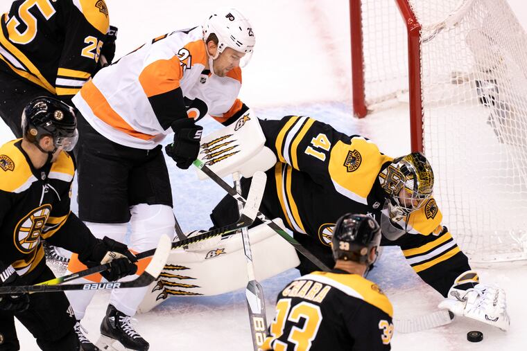 Boston Bruins goaltender Jaroslav Halak (41) covers the puck under pressure from Flyers left winger James van Riemsdyk (25) during the round-robin tourney on Aug. 2. The Flyers and Bruins are among the strong division contenders this season.