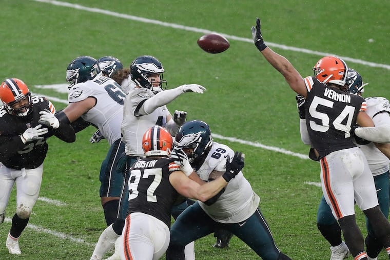 Carson Wentz throws a pass over the outstretched arm of Browns defensive end Olivier Vernon (54). Wentz had two more interceptions and was sacked five times.