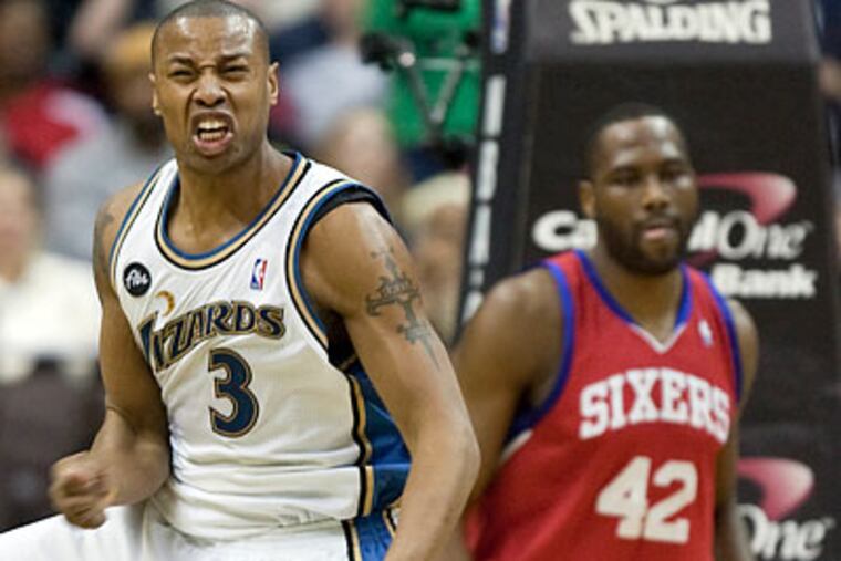 Washington's Caron Butler celebrates after scoring a basket in front of Elton Brand during the fourth quarter. (Evan Vucci/AP)