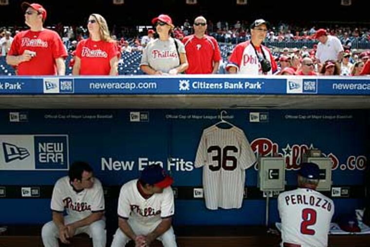 Robin Roberts' No. 36 jersey hangs in the dugout as Jamie Moyer and coach Sam Perlozzo get ready for the Cardinals. (David Swanson/Staff Photographer)