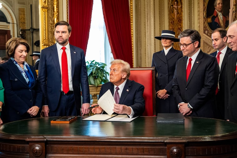 President Donald Trump signs executive orders at the White House.