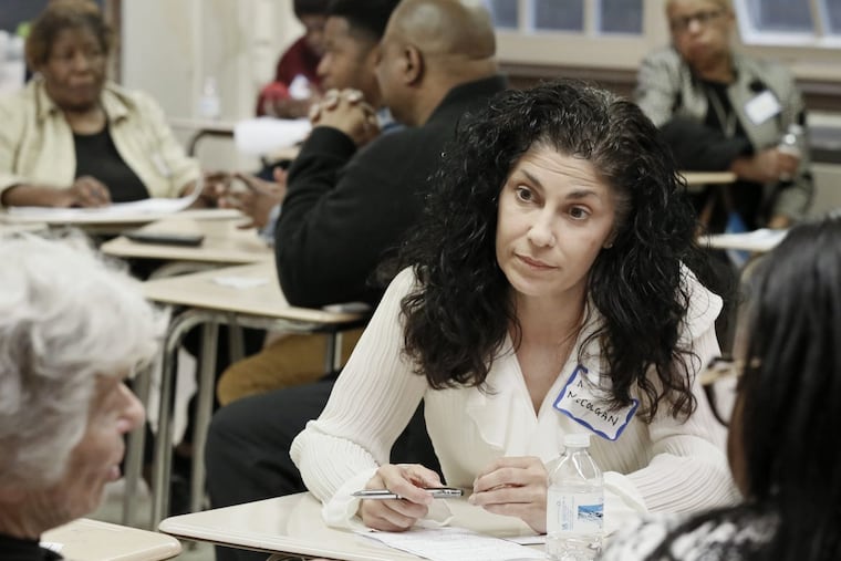 New Philadelphia school board member Maria McColgan (facing camera) listens as she participates in a small group session aimed at improving education for Philadelphia students.