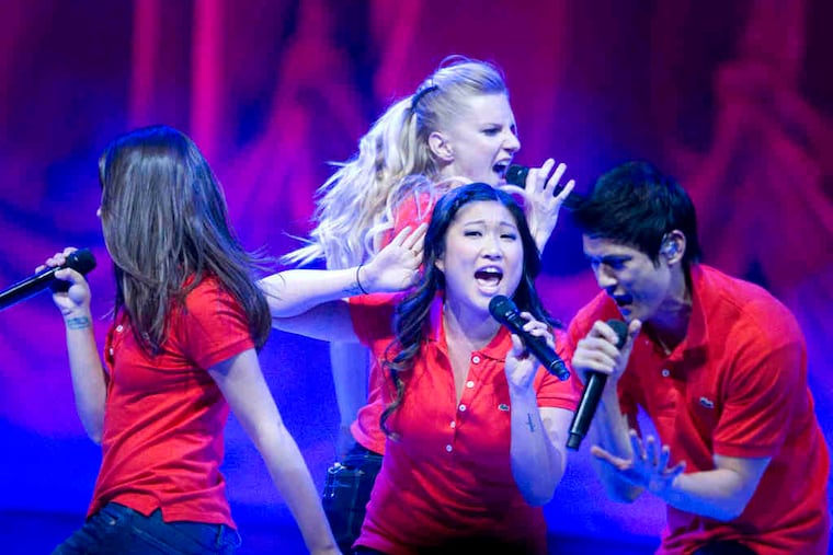 Left, Heather Morris (rear) Jenna Ushkowitz (center), and Harry Shum Jr., and above, Lea Michele, in the live cast performance of "Glee" at the Wells Fargo Center Wednesday. The concert was big on energy and spec- tacle: fireworks, smoke, pyrotechnics.