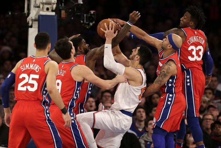 Sixers defenders swarm over the New York Knicks’ Enes Kanter during the second half of Monday’s 105-98 win.