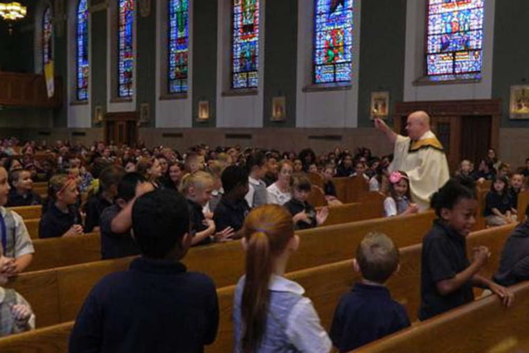 PHOTOS: COURTESY OF ST. TIMOTHY The Rev. Michael Olivere , pastor at St. Timothy's, celebrates the end-of-year closing Mass for Blessed Trinity students.
