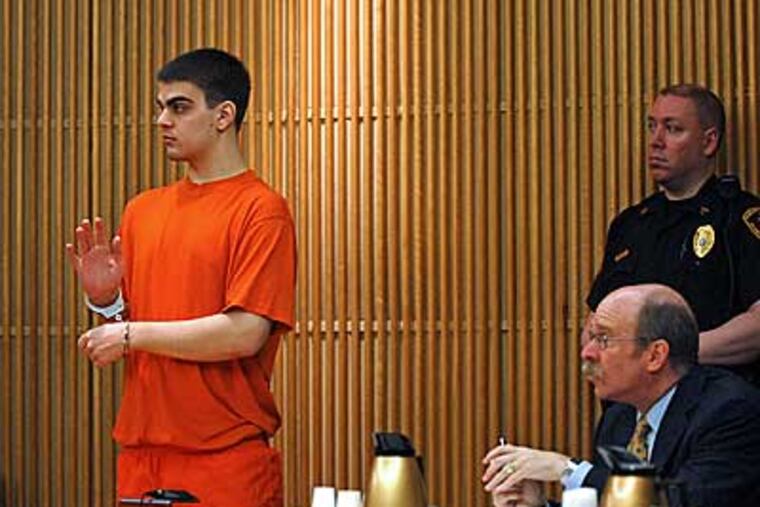 Gloucester County teenager Jason Henry (left) raises his hand-cuffed right hand to swear an oath as he is is sentenced in State Superior Court in Woodbury. ( Tom Gralish / Staff Photographer )
