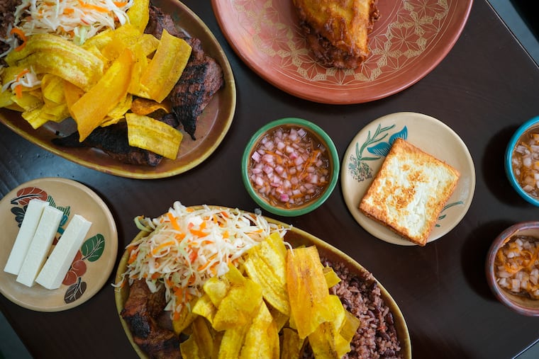 A feast at Pinolero, clockwise from top left: res asada, enchilada, queso frito, cerdo asada, and Chontales cheese, with housemade hot sauce at center.