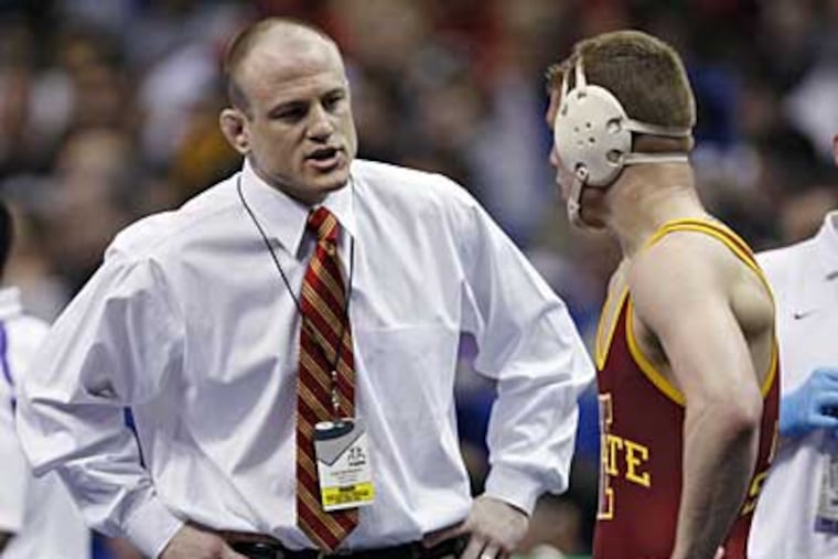 Cael Sanderson, left, gives some last minute advice to his brother Cyler Sanderson, while at Iowa State. (AP Photo / Tom Gannam)