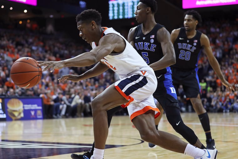 Virginia guard De'Andre Hunter (12) loses the ball while driving past Duke forward RJ Barrett (5) during the second half of an NCAA college basketball game Saturday, Feb. 9, 2019, in Charlottesville, Va. (AP Photo/Zack Wajsgras)