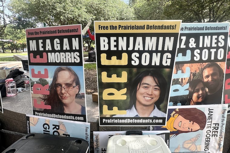 Supporters of protesters convicted in a shooting outside a Texas immigration detention center display signs in support of the defendants outside a federal courthouse in Fort Worth, Texas on Tuesday, June 23, 2026.