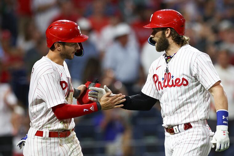 Bryce Harper celebrates his fourth inning two run home run with teammate Trea Turner.