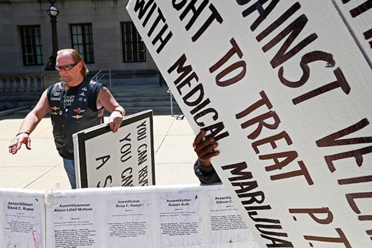 Don Karpowich, of Morristown, takes part in a protest in front of the State House Annex in Trenton, N.J., Thursday, May 7, 2015. Karpowich, a vet who worked as a Special Ops soldier, suffers from Post Traumatic Stress Disorder (PTSD) and says medicinal marijuana has helped keep him calm and given him the ability to live as normal a life as possible. ( Rich Schultz / For The Inquirer )