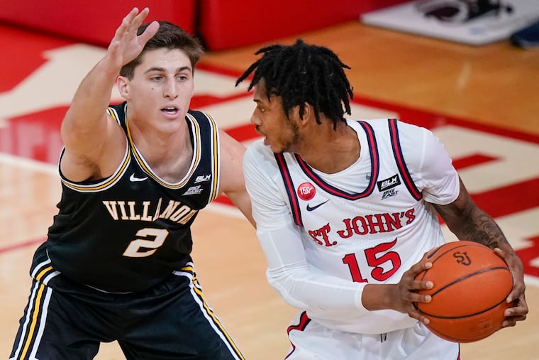 Villanova's Collin Gillespie (2) defends St. John's Vince Cole (15) during the first half of an NCAA college basketball game Wednesday, Feb. 3, 2021, in New York.