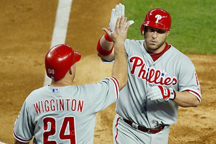 Laynce Nix celebrates with Ty Wigginton after hitting a home run in the fourth inning. (Matt York/AP)
