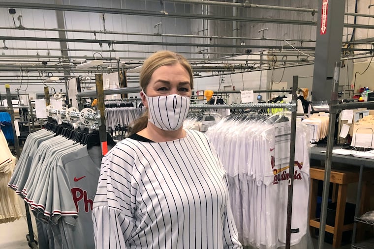 Workers at Fanatics' Majestic factory near Easton model one-use hospital masks and gowns made from Major League Baseball uniforms fabric after Pennsylvania shut down all but "essential" production to cut coronavirus transmission risk. March 2020