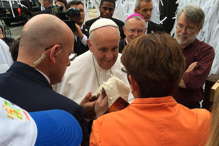 Sister Mary Scullion presents Pope Francis a stole knit with the prayer knots from prisoners, homeless and mentally ill as he visited the Knotted Grotto outside St. Peter's Basilica on Sept. 27,2015. ( Mari A. Schaefer / Staff )