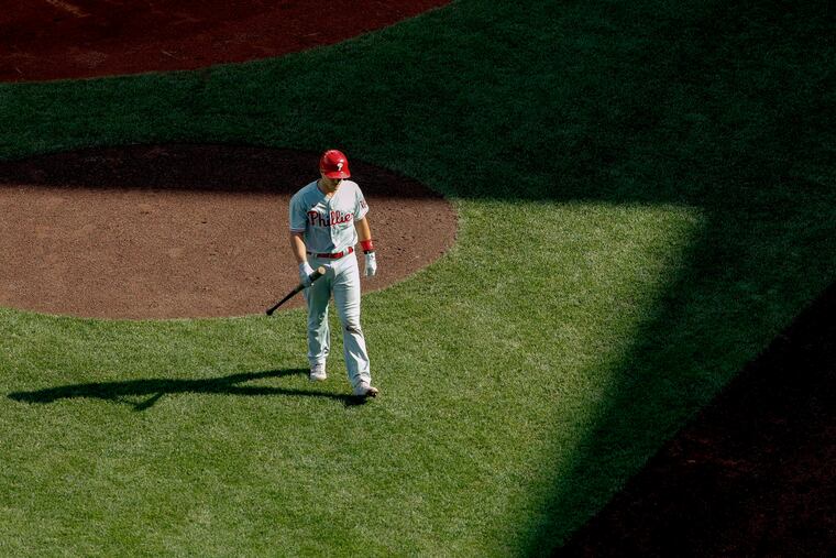 Phillies catcher J.T. Realmuto heads back to the dugout after striking out in the seventh inning.