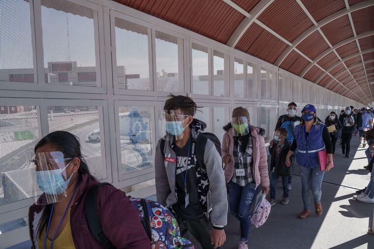 Migrants in Migrant Protection Protocols (MPP), or the "Remain in Mexico Policy", enter the United States at the Paso del Norte Bridge between El Paso, Texas and Ciudad Juarez, Mexico on March 11, 2021.