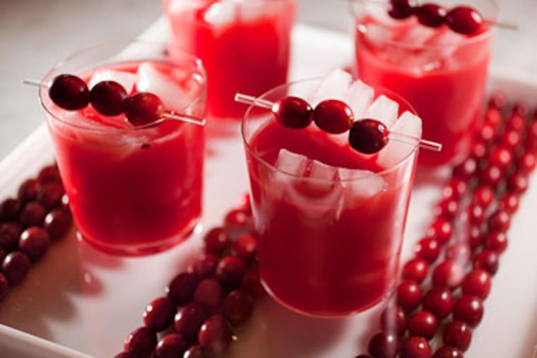Cranberry-tinis on a square tray lined with cranberries by Peter Callahan. Get the recipe <a href="http://www.philly.com/philly/restaurants/recipes/134778028.html"> here</a>. (David M Warren / Staff Photographer)