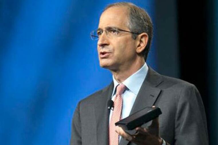 Comcast CEO Brian Roberts holds the company's future Xi3 box, which is cheaper, smaller and more energy-efficient than the X1. (File photo)