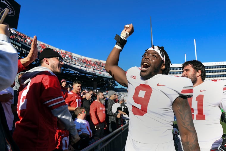 Ohio State defensive end Zach Harrison (9) celebrates with fans after defeating Penn State 44-31 in an NCAA college football game, Saturday, Oct. 29, 2022, in State College, Pa. (AP Photo/Barry Reeger)