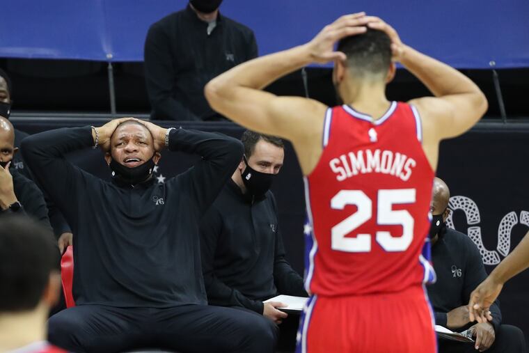 Coach Doc Rivers, left, and Ben Simmons of the SIxers express disbelief in an official’s call during their game against the Wizards at the Wells Fargo Center on Wednesday.