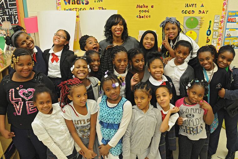 Oshunbumi Fernandez (center) stands with girls in her "I Am B.U.M.I." program. (CLEM MURRAY / STAFF PHOTOGRAPHER)