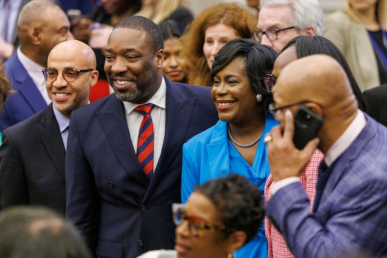 Philadelphia Mayor Cherelle L. Parker stand beside Council President Kenyatta Johnson (left) after she finishes her budget address to City Council on March 13.