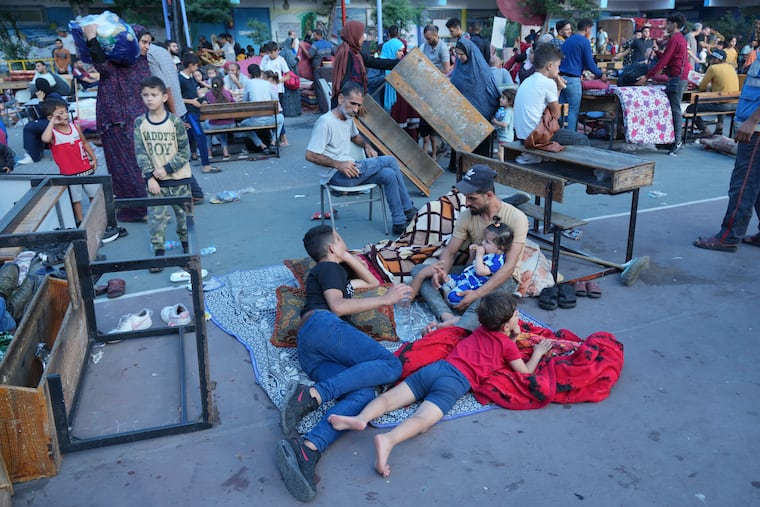 Palestinians take shelter in a U.N.-run school from the ongoing Israeli strikes on the Gaza Strip in Nuiserat refugee camp on Saturday, Oct. 14, 2023.