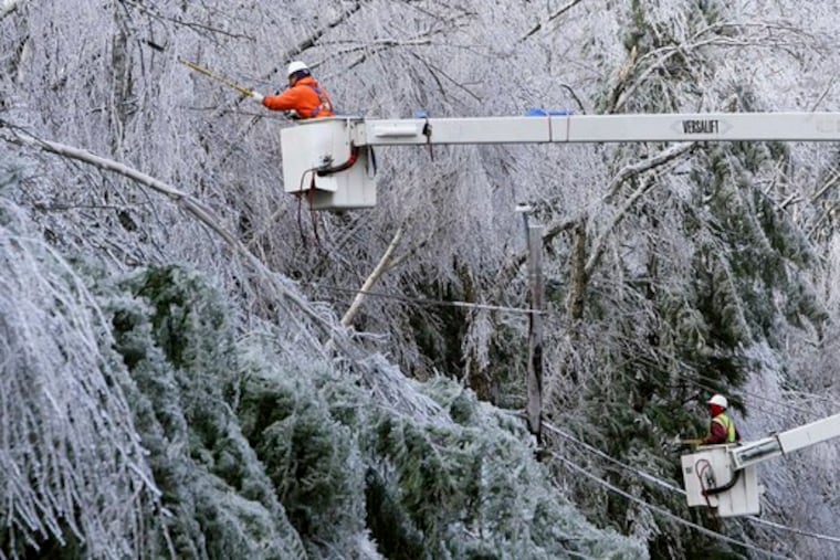 Lamont Priest (left) and Raheem Jefferson of Lewis Tree Service, in Bethlehem, Conn., cut iced tree limbs to get to powerlines in Temple, N.H. They worked yesterday as temperatures got as low as single digits in New Hampshire and Maine.