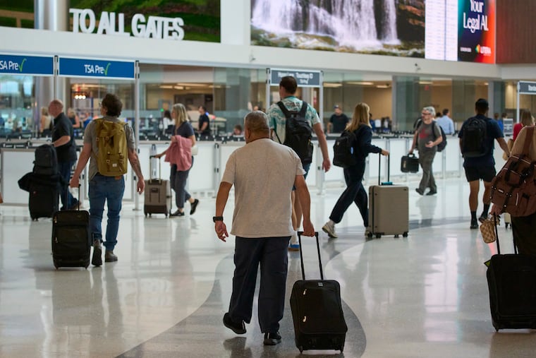 Travelers make their way through Nashville International Airport, Friday, Aug. 28, 2026, in Nashville, Tenn. A push is on to rename the airport for beloved music star Dolly Parton, who died Tuesday.
