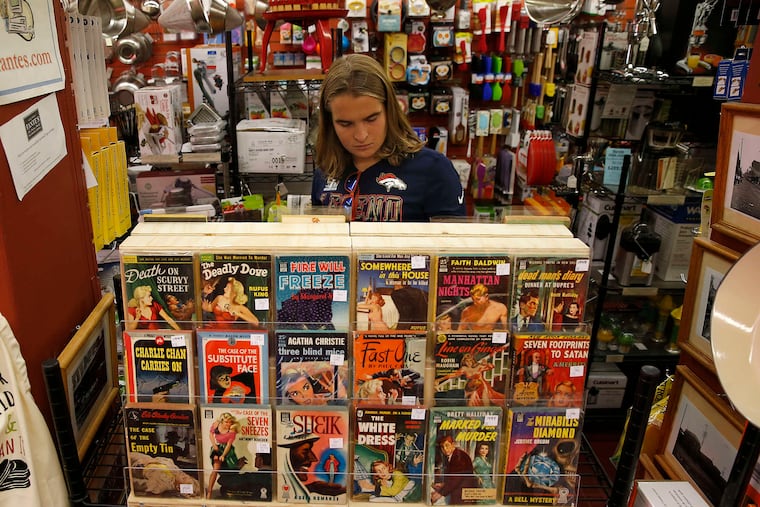 Phillip Reid, a Haverford College student, checks out the book display in Fante's Kitchen Shop.