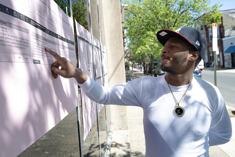 Jerome Upchurch reads voters information posted outside the Fleisher Art Memorial election polling place on Tuesday, Apr 23, 2024, in South Philadelphia, Pa. .