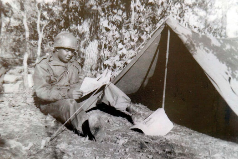 Among Clarence Davis' memorabilia from the Korean conflict is this photograph of him reading the newspaper from home. The wartime experiences of the South Jersey veteran, now 91, have been turned into a beautifully illustrated comic book by his son, filmmaker, music producer, and writer Gary Davis.