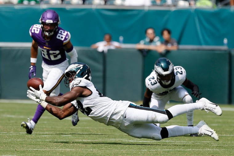 Eagles linebacker Oren Burks dives for the football in the third quarter. He didn't intercept the pass but finished with seven tackles.