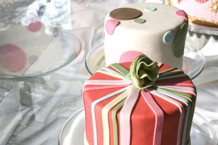 A variety of cakes are displayed in the window of the Night Kitchen Bakery. Special-order cakes for weddings, anniversaries, and bar and bat mitzvahs also are a house specialty. (CHARLES FOX / Staff Photographer)