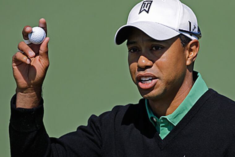Tiger Woods acknowledges applause after putting on the second green during the second round of the Masters. (AP Photo/Chris O'Meara)