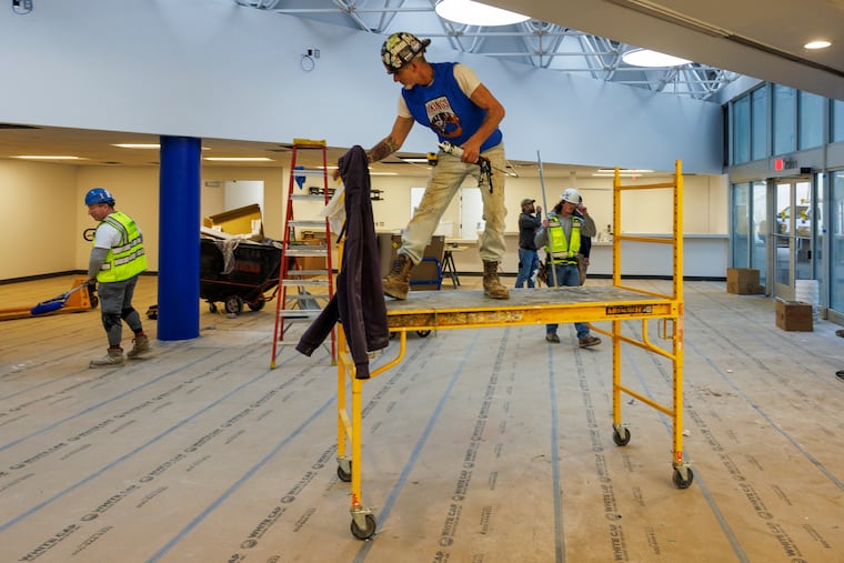 Workers finishing up the rehab of the former Greyhound Station at 10th and Filbert Streets, Center City Philadelphia, Wednesday, April 22, 2026.