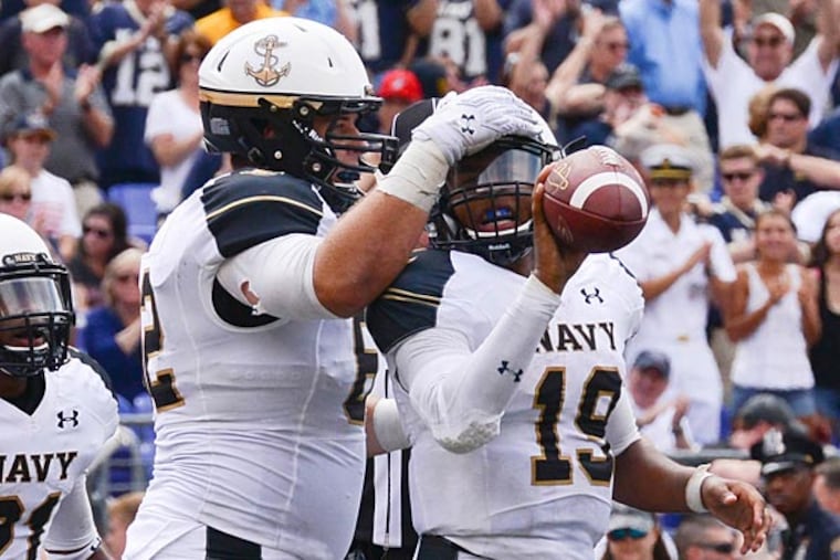 Navy Midshipmen quarterback Keenan Reynolds (19) celebrates with his teammates after scoring on a one-yard touchdown run during the third quarter against the Ohio State Buckeyes at M&T Bank Stadium. Ohio State Buckeyes defeated Navy Midshipmen 34-17. (Tommy Gilligan/USA Today)