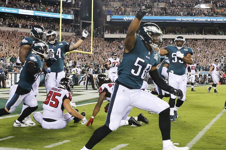 Eagles Jordan Hicks celebrates a fourth-down stop on Atlanta Falcons running back Devonta Freeman.