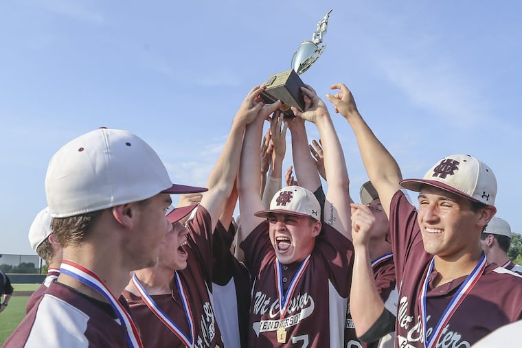 Henderson’s Justen Lucas holds the championship trophy with teammates after beating Marple Newtown, 3-1, in eight innings to win the PIAA District 1 Class 5A baseball championship in Plymouth Meeting, Tuesday May 29, 2018