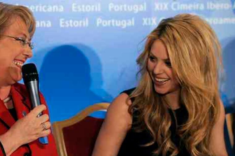 Shakira, 32, met in Estoril, Portugal, yesterday with Latin American presidents including Michelle Bachelet of Chile, seeking more spending on child education and health. The singer set up her charitable foundation when she was 18. Below, in Potsdam, Germany, last week, she displayed her Bambi award for excellence in international media.