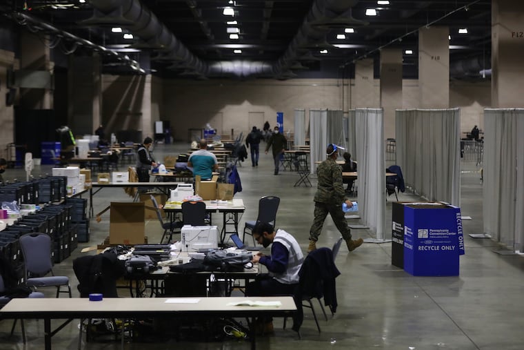 Officials work inside the first day of the FEMA COVID-19 vaccination site at the Pennsylvania Convention Center on March 3.