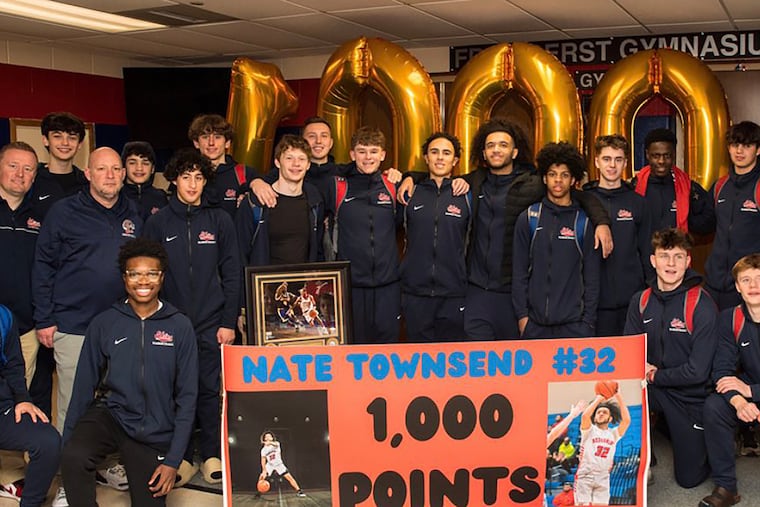Nate Townsend and his Neshaminy teammates celebrate his 1,000th career point.