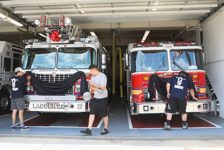 Black bunting is draped on the rescue vehicles at Belmont Hills Fire Company in memory of firefighter Tom Royds in July. Royds died and three other first responders were severely injured after a driver struck them at the scene of another car crash in the westbound lanes of I-76.