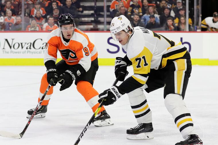 Flyers defenseman Ivan Provorov (left) defending Penguins center Evgeni Malkin during a game last season.