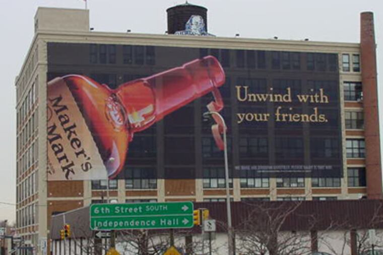 This photo taken in February 2005 shows wall wraps erected illegally on the building at 7th and Willow streets. (Photo credit: SCRUB)