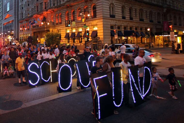 Protesters marching against education cuts on Broad Street in October. The protest began as a candlelight vigil at Gov. Corbett's Philadelphia office.