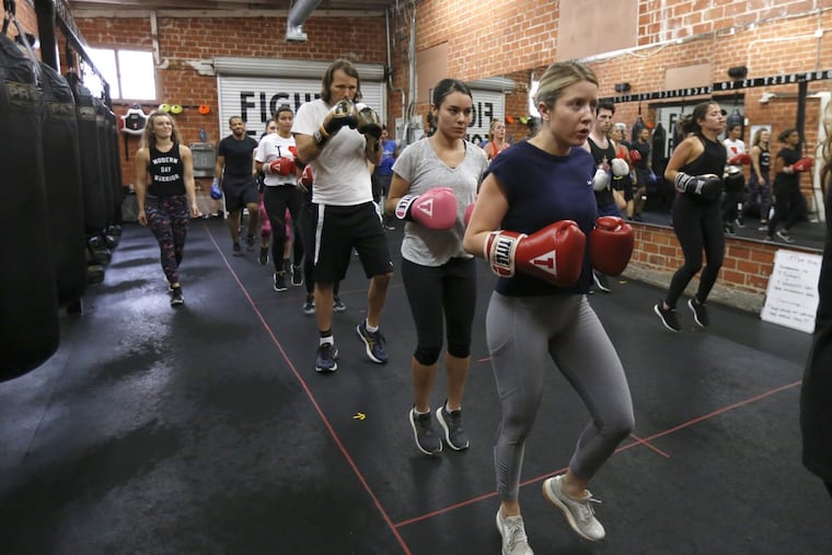 Boxing instructor Kendall Wood (left) leads the boxing fitness class at Prevail Boxing in Los Angeles.